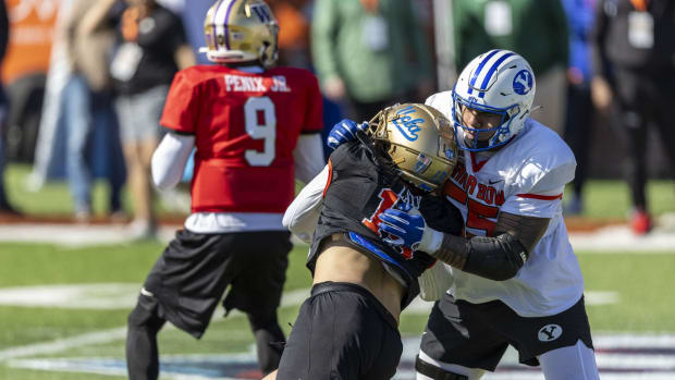 Jan 30, 2024; Mobile, AL, USA; National offensive lineman Kingsley Suamataia of Byu (55) battles National edge Laiatu Latu of Ucla (15) during practice for the National team at Hancock Whitney Stadium.